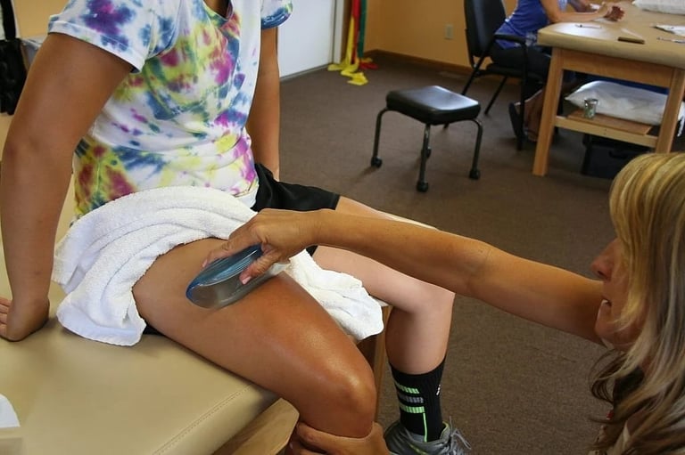 Medical professional applying bandage or medical tape to patients leg in clinical setting